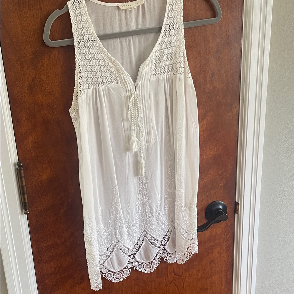 White sleeveless Lovestitch top with lots of details.